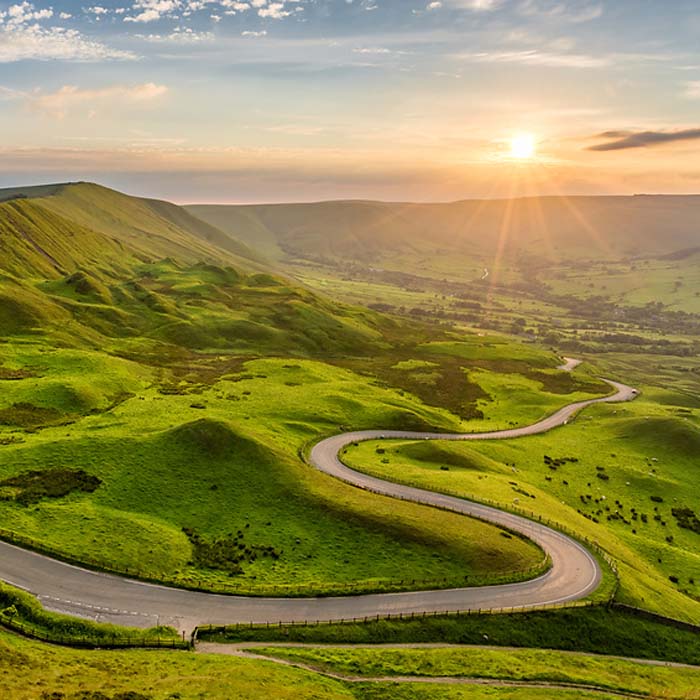 Long winding country road leading through rural countryside in t